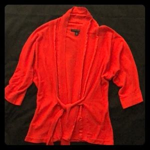 Orange colored tie up sweater